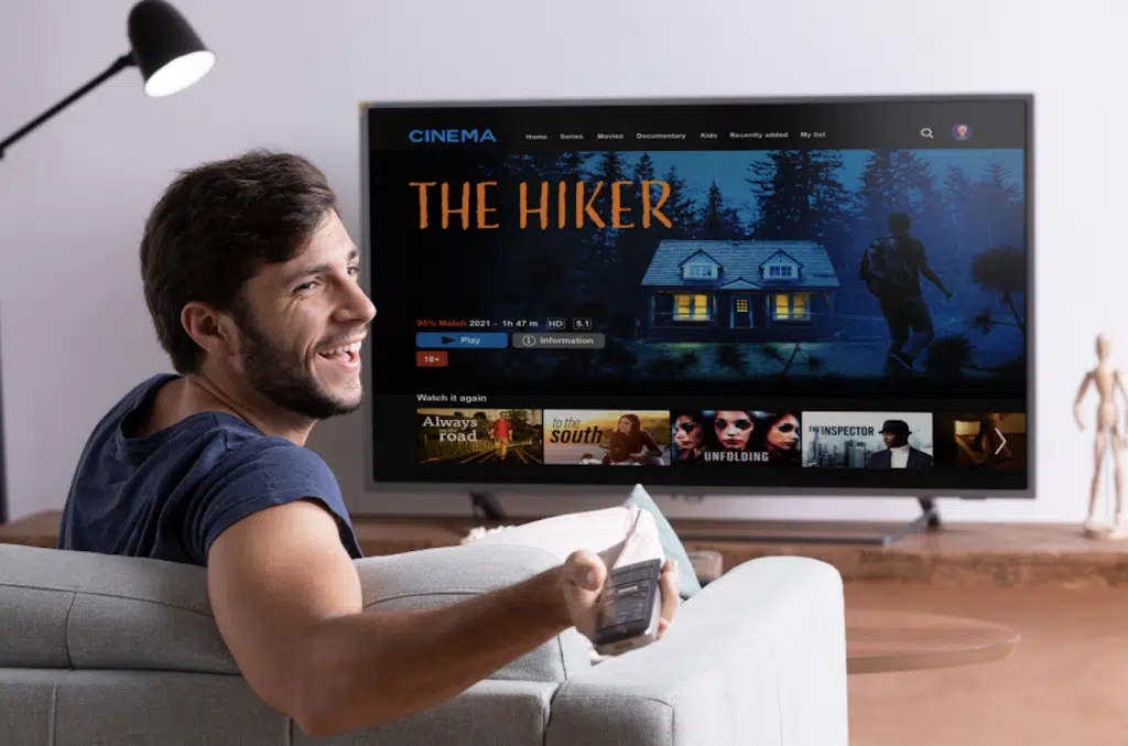 Man enjoying buffer-free IPTV streaming on Smart TV