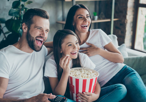 Family enjoying IPTV streaming together with popcorn